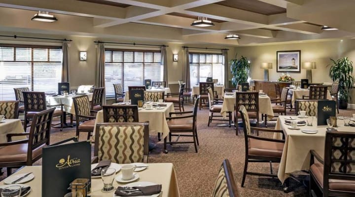 Bright dining room with tables set for meals