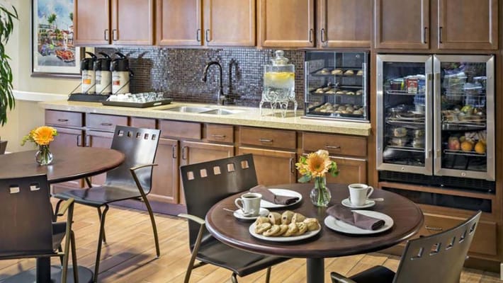 Dining area with coffee, snacks, and flowers