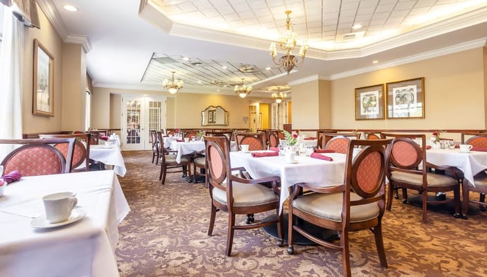 Elegant dining room with tables set for meals