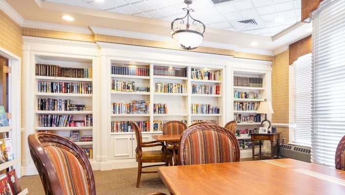 Cozy interior of a library with bookshelves and tables