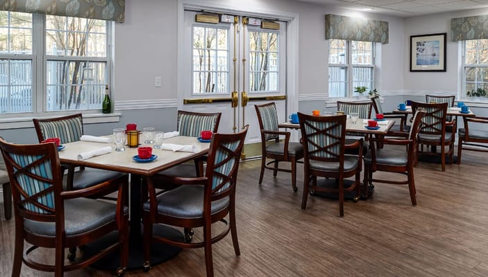 Bright dining room with tables set for meals