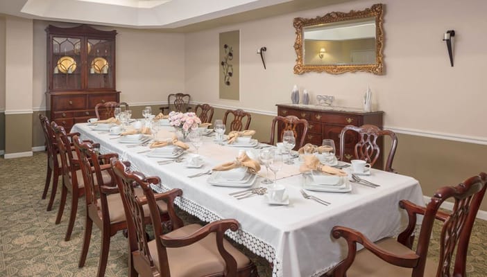 Dining room set for a meal with elegant table settings