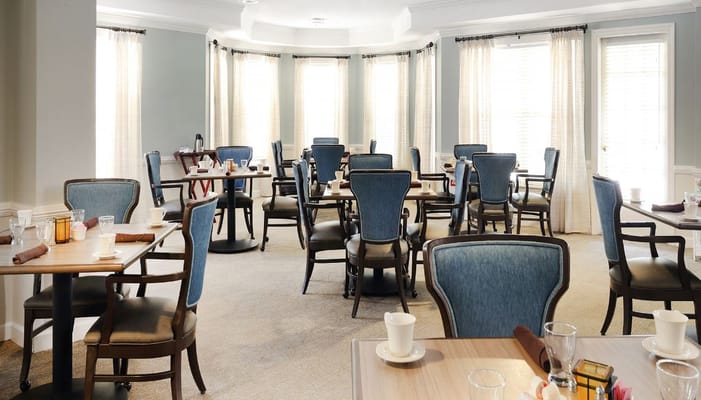 Dining room setup with empty tables and chairs