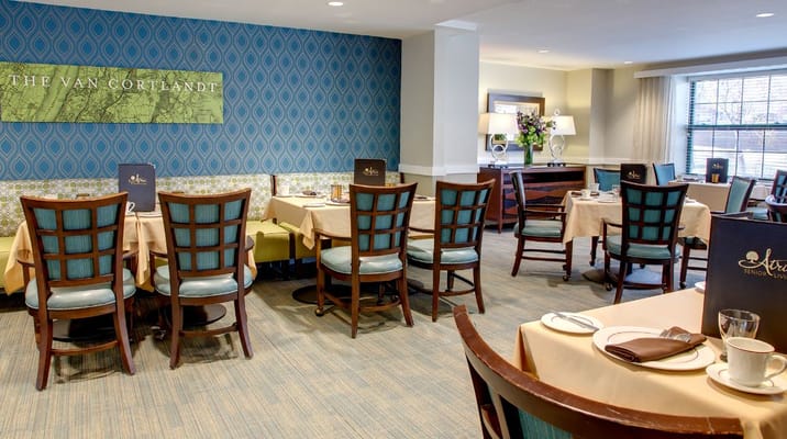 Dining area with neatly set tables and decor