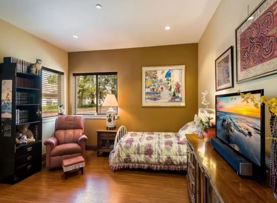 Cozy private resident room with a bed and seating area