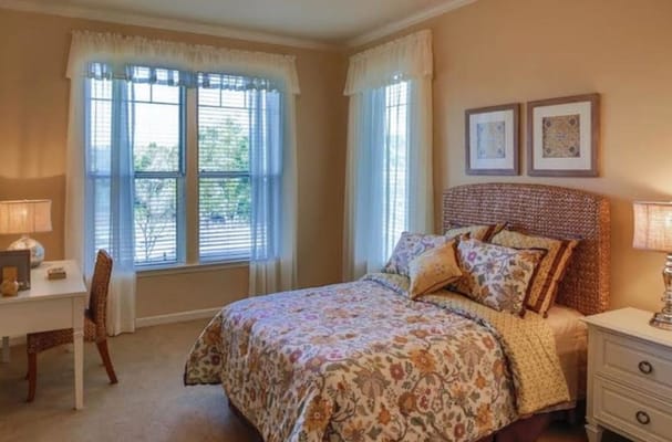 Private resident room with a bed and desk