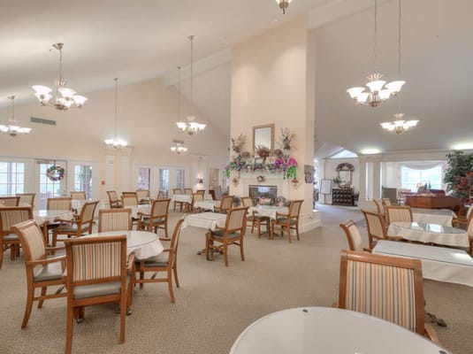 Spacious dining room with tables and chairs at Azalea Estates of Gonzales.