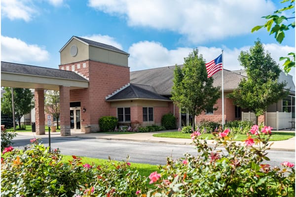 Exterior view of a nursing home facility with greenery