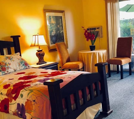 Cozy private room with a bed and armchairs