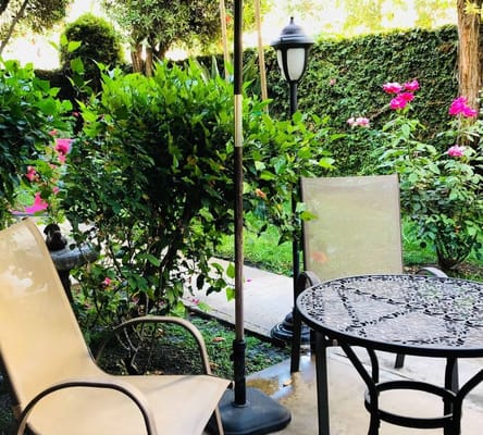 Seating area in a garden with flowers.