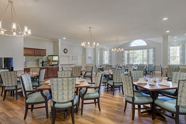 Bright dining area with tables and chairs set up