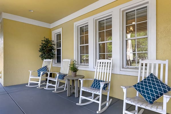 Outdoor seating area with rocking chairs and decorative pillows
