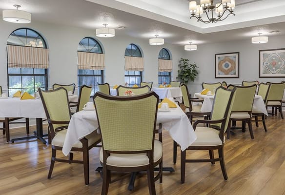 Bright dining area with tables set and decorated