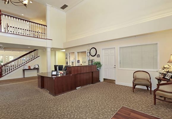 Bright interior of a nursing home lobby with reception.