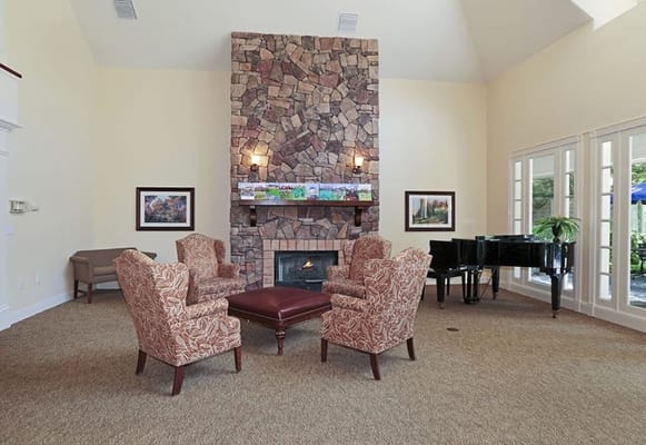 Cozy common area with patterned chairs and a fireplace