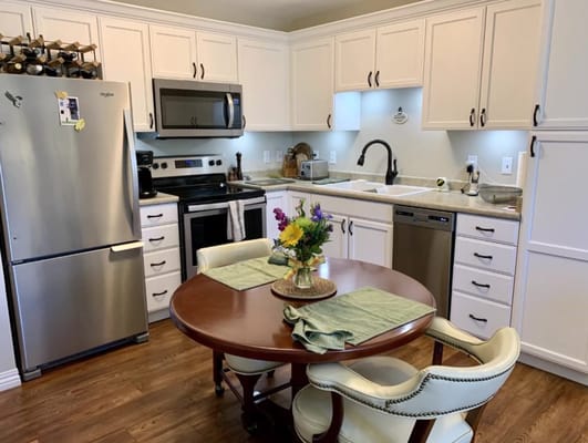 Bright kitchen area with a round dining table and modern appliances