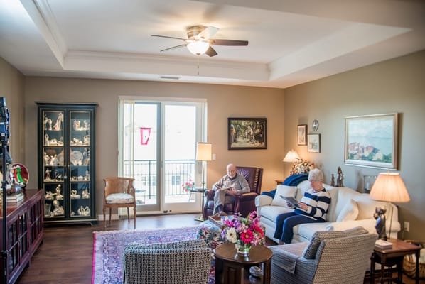 Two seniors enjoying time in a cozy living room