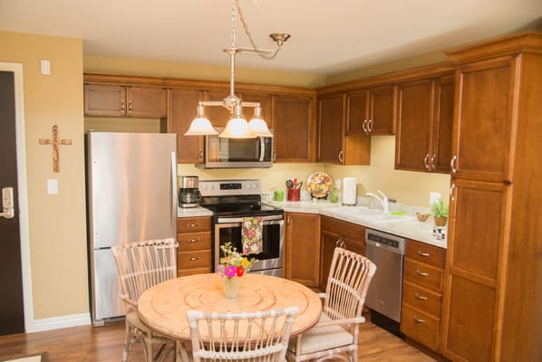Cozy kitchen area with wooden cabinets and dining table