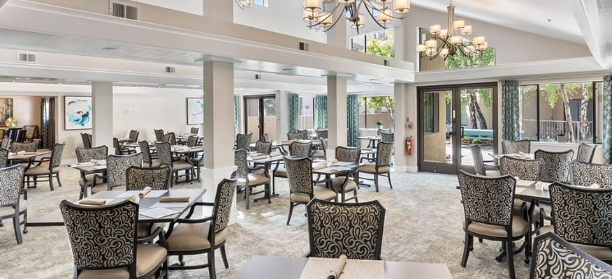 Bright dining room with tables set for meals