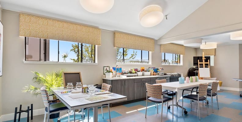 Bright activity room with tables and art supplies