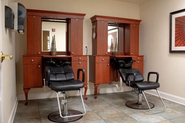 Hair salon area with styling chairs and mirrors