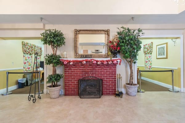 Interior view of a decorated common area with a fireplace