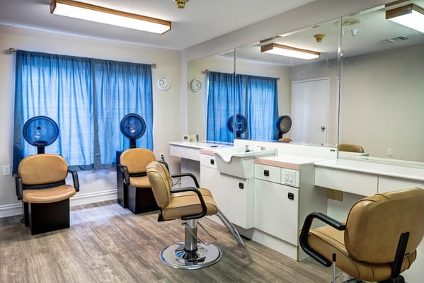 Bright salon area with styling chairs and mirrors