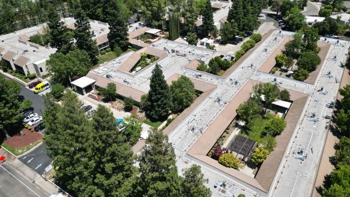 Aerial view of a senior living facility with gardens
