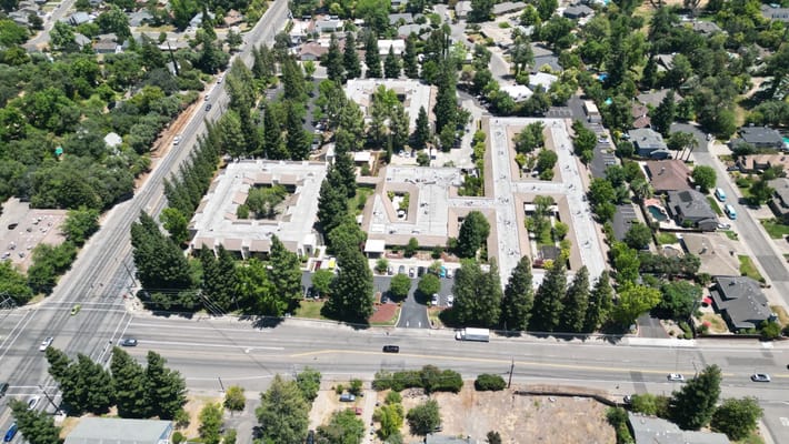 Aerial view of a senior living facility surrounded by trees