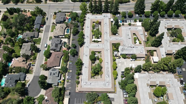 Aerial view of a senior living facility with gardens