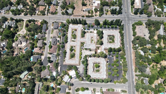 Aerial view of a senior living facility with surrounding homes