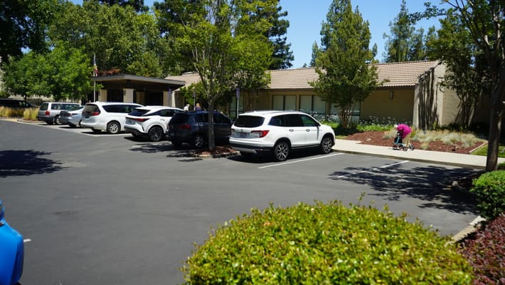 Exterior view of the facility with parking lot and trees