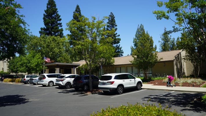 Exterior view of the facility with parked cars