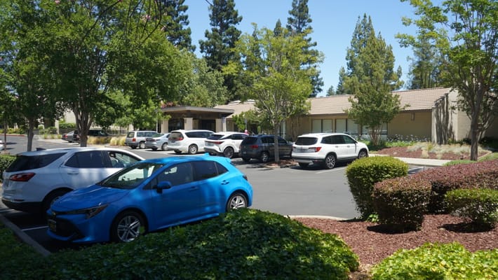 Exterior view of a senior living facility with parking