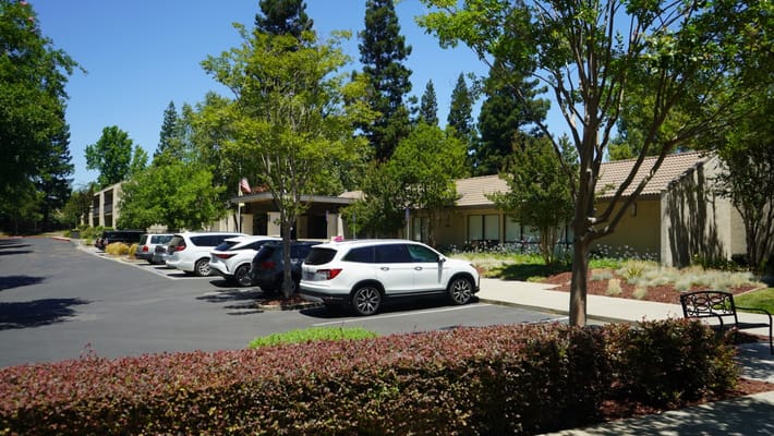 Exterior view of a senior living facility with parking
