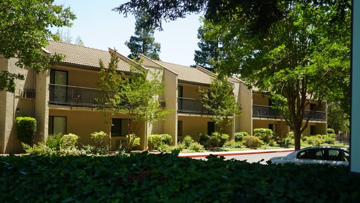 Exterior view of a senior living facility with greenery