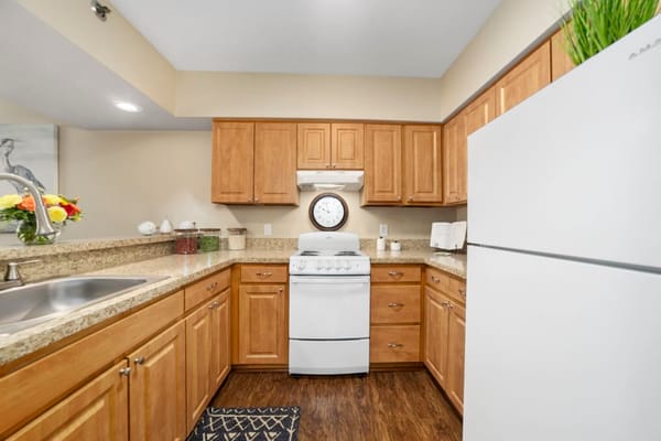 Modern kitchen with wooden cabinets and white appliances