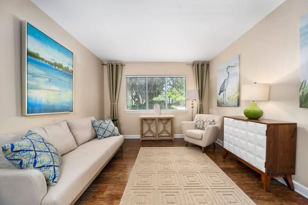 Bright and inviting living room with comfortable seating and art decor