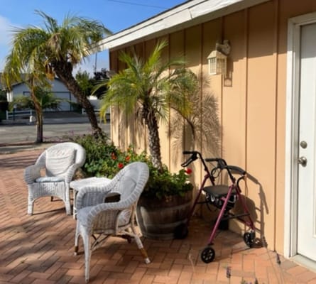 Outdoor seating area with a walker and plants