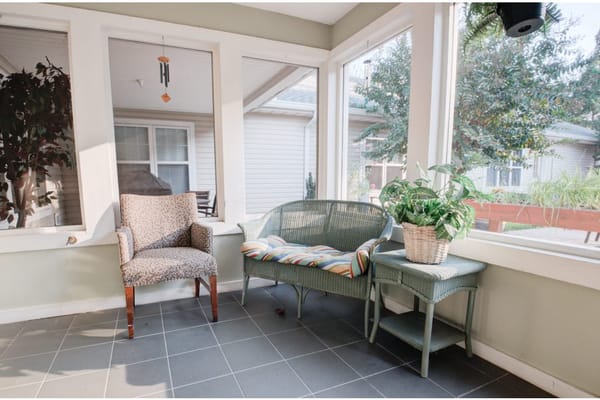 Bright sunroom with seating and plants