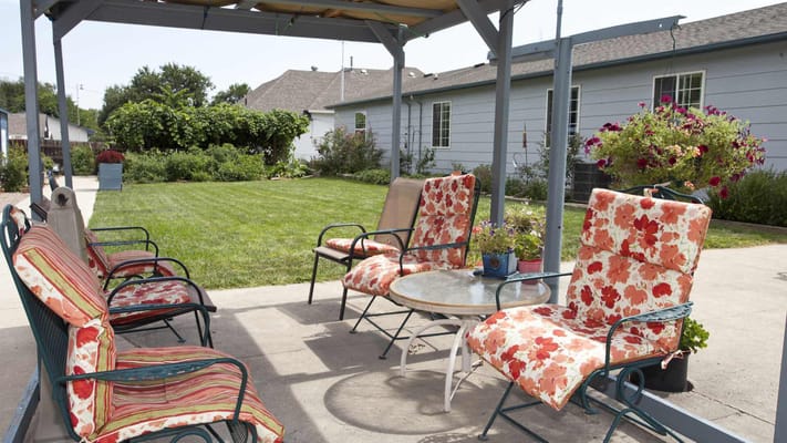 Outdoor seating area with flowers and grass