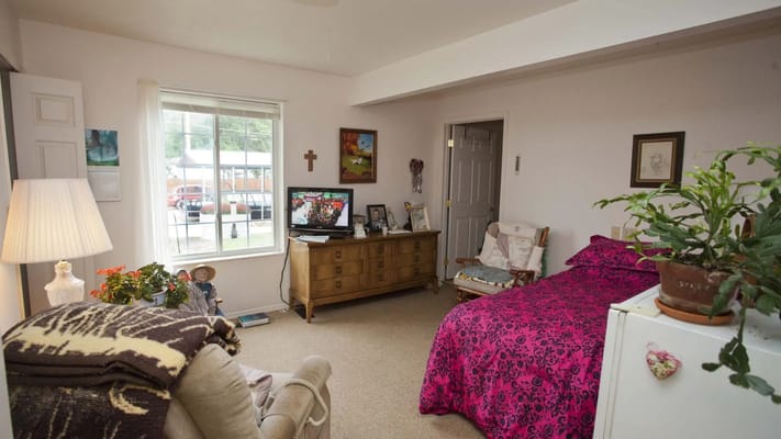 Cozy resident room with a bed and television