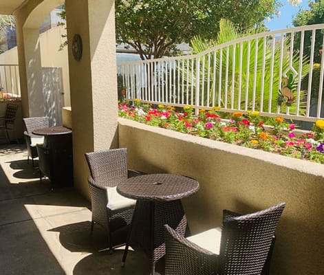 Patio area with tables and colorful flowers
