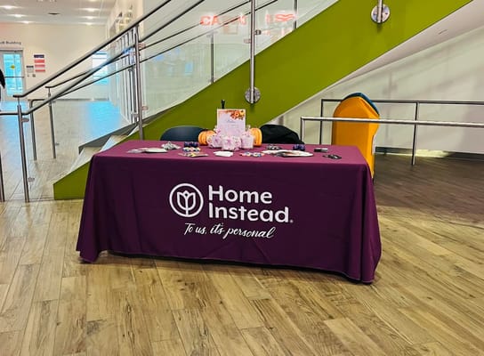 Home Instead logo on a table in an interior space