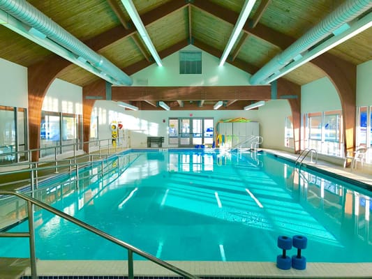 Indoor swimming pool with natural light and safety equipment