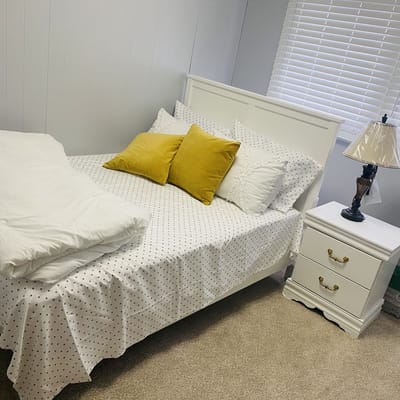 Cozy bedroom setup with white bedding and decorative pillows