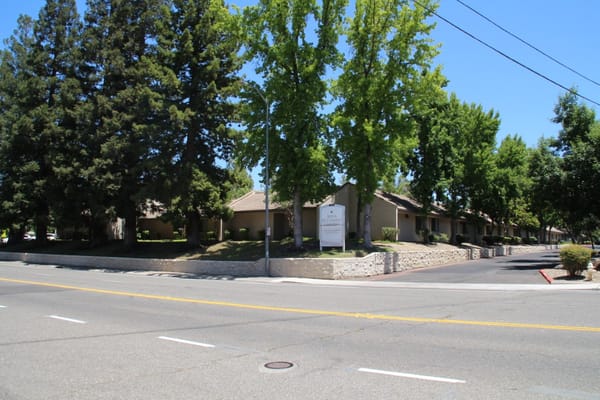 Exterior view of a senior living facility with trees