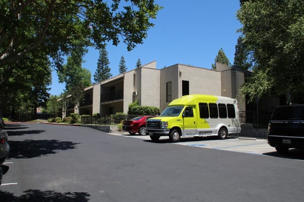 Building exterior with facility transport vehicle and cars