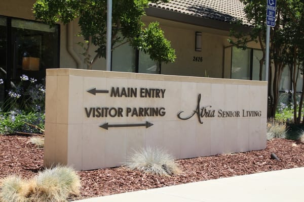 Sign directing to main entry and visitor parking