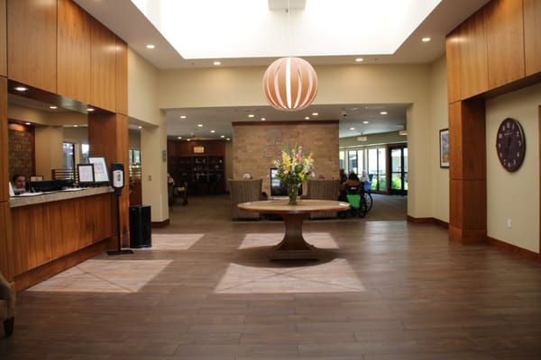 Bright lobby area with a reception desk and seating